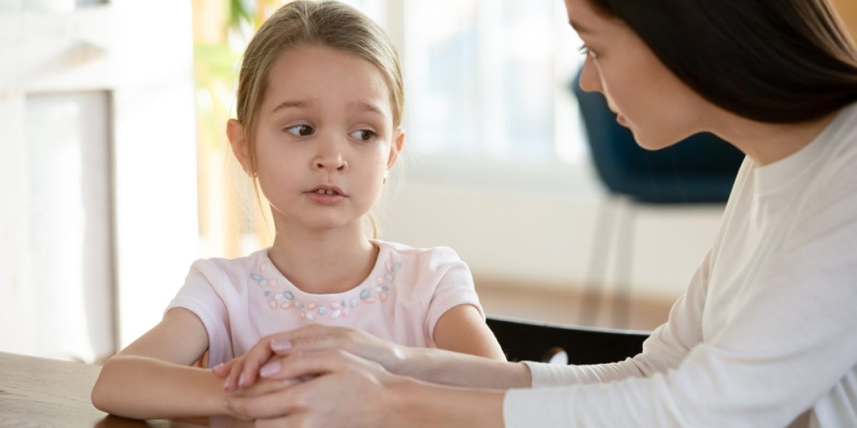 Head,Shot,Unhappy,Small,Child,Girl,Sitting,At,Table,With